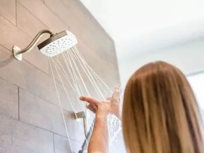 A woman is using a shower